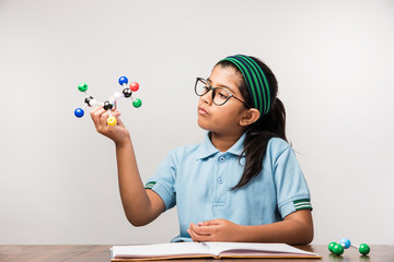 Indian Female student Using Molecular Model Kit for studying Science, selective focus