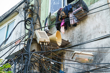 Public loudspeaker with surrounded electrical wires in old town of Hanoi