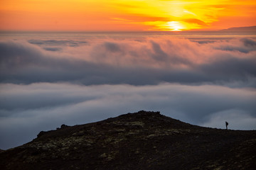  Dreamy misty landscape above the sea of clouds, mountains at sunset in Iceland