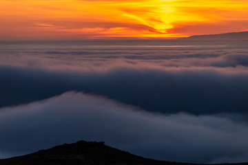  Dreamy misty landscape above the sea of clouds, mountains at sunset in Iceland
