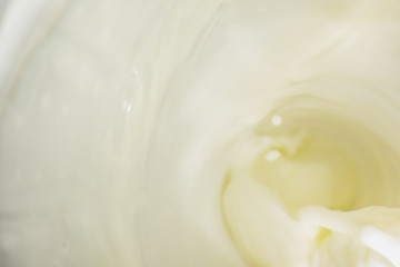 Fototapeta na wymiar Bright milk surface with splashes