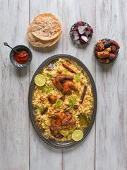 Chicken Mandi with dates on a wooden table. Arabic cuisine