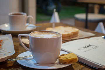 Cafe Table with Cappuccino Coffee dish with pastries