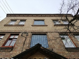 Fototapeta premium Bottom-up view of the facade of residential building in Stalinist architecture in the afternoon.