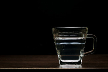 The water in the glass looks fresh and pure on the table.