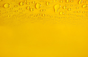 Water drops on yellow background