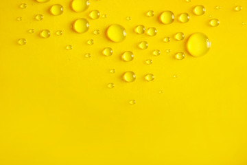 Water drops on yellow background