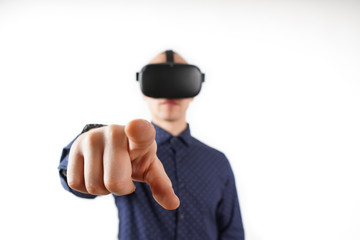 Young man wearing virtual reality glasses during a working break. Behind them is a pure white background.