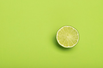 Lime slice on green background