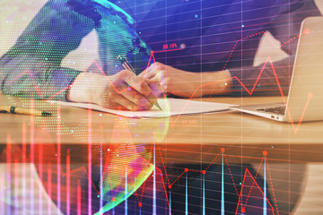 Double exposure hands with stock market chart.