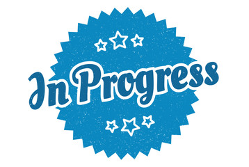 Fototapeta premium in progress sign. in progress round vintage retro label. in progress