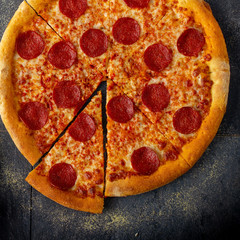 Tasty pepperoni pizza over a rustic background