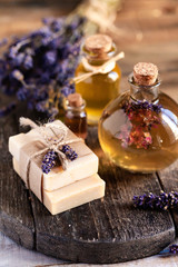 Concept of natural handmade home soap with organic oil for gentle skin care. Pleasure, relax, anti-stress. Atmosphere of harmony and serenity. Wash hand in epidemy. Wooden rustic background, closeup.
