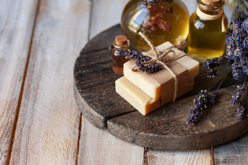 Concept of using natural organic oil in cosmetology. Moisturizing skin care and aromatherapy. Gentle body treatment. Handmade soap. Atmosphere of harmony, relax. Wooden background copy space for text