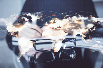 International business hologram over woman's hands taking notes background. Concept of success....