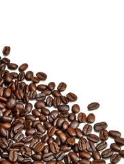 Scattered roasted coffee beans isolated on white background