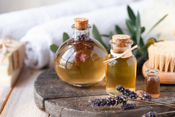 Concept of natural organic oil in cosmetology. Moisturizing skin care and aromatherapy. Gentle body treatment. Handmade soap. Atmosphere of harmony, relax. Wooden background, lavender flowers - obrazy, fototapety, plakaty