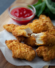 Crispy chicken strips with ketchup