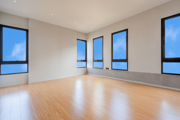 Empty room interior with windows overlooking the blue sky, Beautiful wooden floor and white wall modern architecture