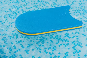 Schilderijen op glas flutter board in swimming pool with blue water © LIGHTFIELD STUDIOS