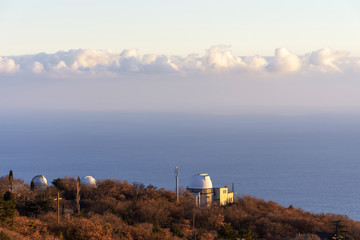 Fototapeta na wymiar white domes of telescopes at the Simeiz observatory on the background of the sea