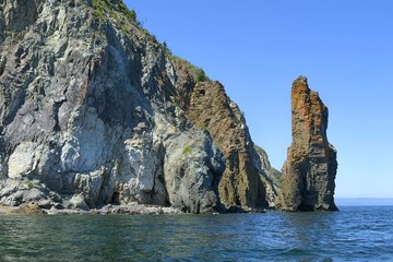Fototapeta na wymiar Rocks and sea stacks on the Tatar strait coast. Ivanov cape, Sikhote-Alin mountain ridge. Khabarovsk region, far East, Russia.