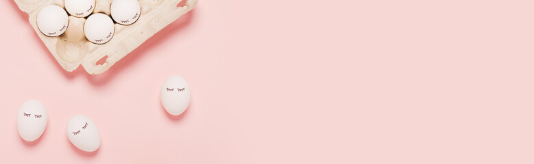Festive Easter pink web banner with white eggs and eyes drawn on them. The inscription is a happy Easter.