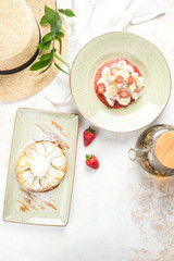 Dessert with strawberries and pear pie shot from above