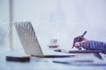 Multi exposure of forex chart with man working on computer on background. Concept of market...