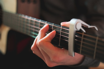 Young man playing on acoustic guitar