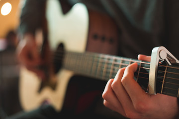 Young man playing on acoustic guitar