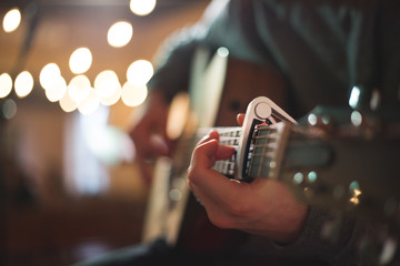 Young man playing on acoustic guitar