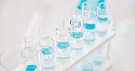 microscope with lab glassware, science laboratory research and development concept