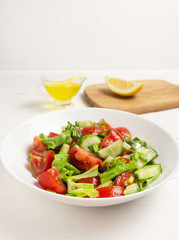 Salad of tomatoes, cucumbers and herbs. Healthy food, vegan, vegetarian.