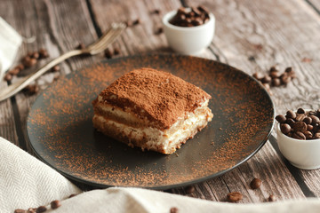 Tiramisu cake on a plate. Romantic composition with coffee and other elements