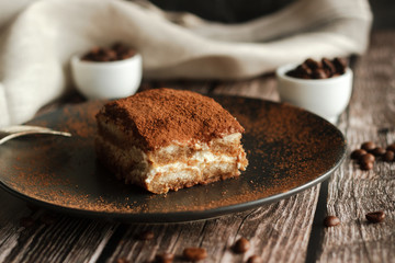Tiramisu cake on a plate. Romantic composition with coffee and other elements