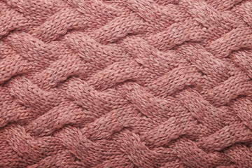 knitted carpet close -up. Textile texture on a white background. Detailed warm yarn background. Knit cashmere beige wool. Natural wool fabric, a fragment of a sweater.