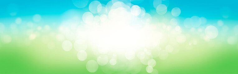 A blurred fresh spring, summer blue and green abstract banner background with bokeh glow.