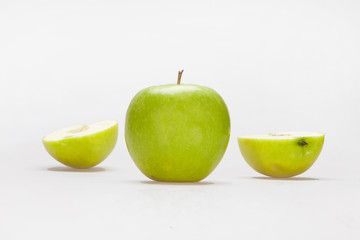 Green Apple with slices on a white background