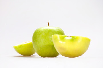 Green Apple with slices on a white background