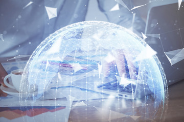 Crypto currency theme hologram with businessman working on computer on background. Concept of...