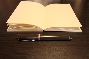 Paperback book notebook and pen