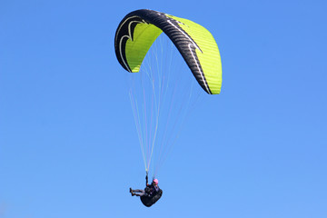 Paraglider flying wing in a blue sky	