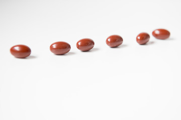 red pills on white background