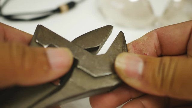 Hand close-up of The repairman is adjusting the width of the wrench.