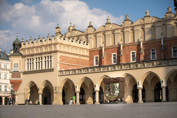 Piggy bank on the background of the Cloth Hall. Main Market Square in Krakow