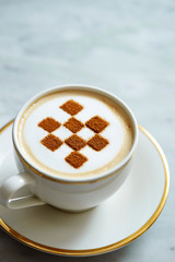 Latte art with checkered pattern 