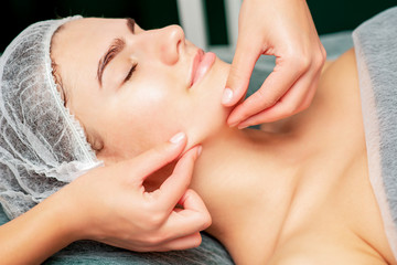 Chin massage of woman.