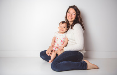 young family mother over white background with the baby child girl