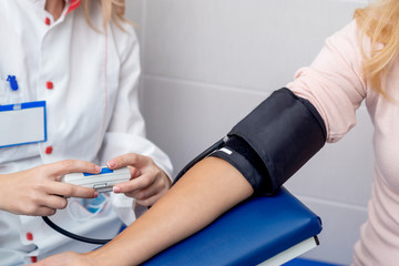 Doctor measures the pressure.